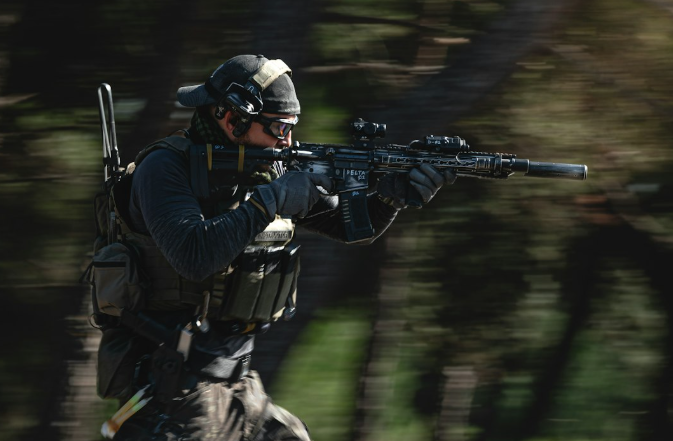 Tactical operator wearing helmet-mounted headset with Bifrost Gear Micro ARC Rail adapter for secure communication.