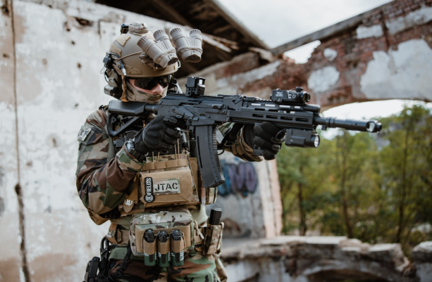 Soldier wearing tactical helmet and headset with COM-RAC AMP Arm Adapters in action