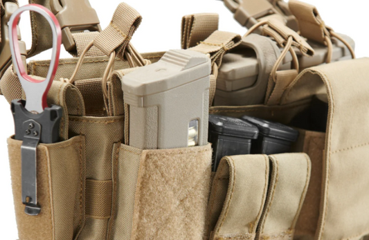 Close-up of tactical chest rig with magazine pouches and gear for military or law enforcement use.